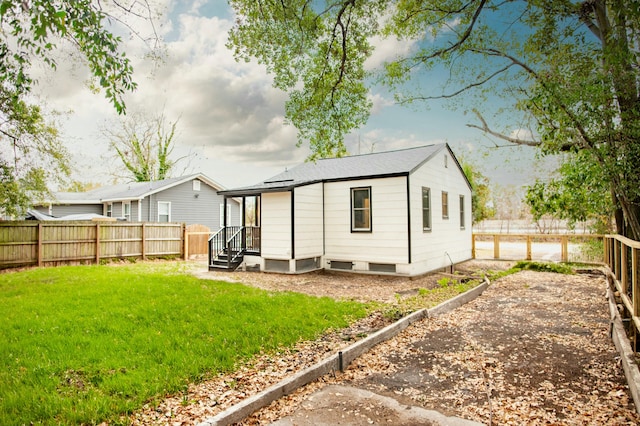 rear view of house with a lawn