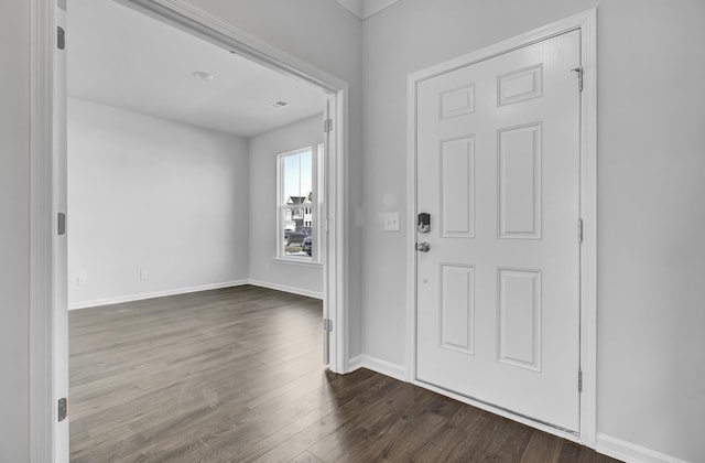 foyer entrance featuring dark wood-style floors and baseboards