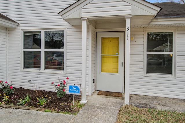 property entrance with roof with shingles