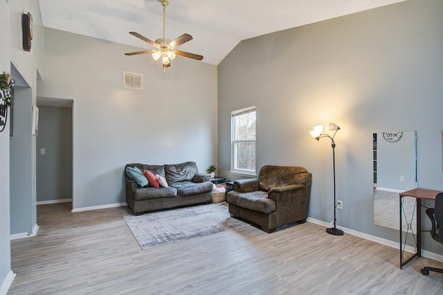 living room featuring wood finished floors, visible vents, and baseboards