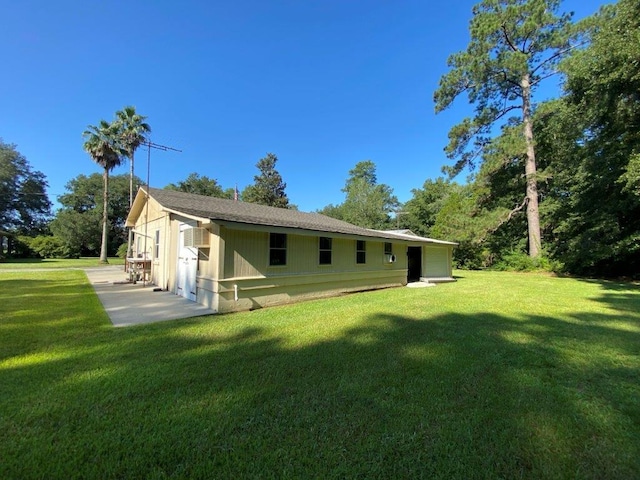 back of property featuring a yard and a patio