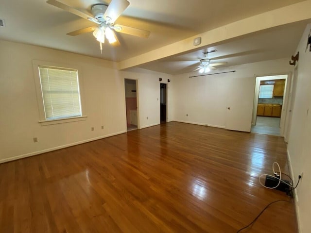 unfurnished room featuring dark wood-type flooring and ceiling fan