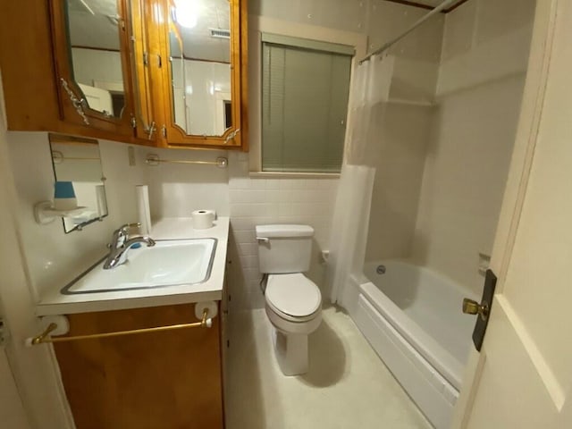 full bathroom featuring vanity, tile walls, shower / tub combo with curtain, and toilet