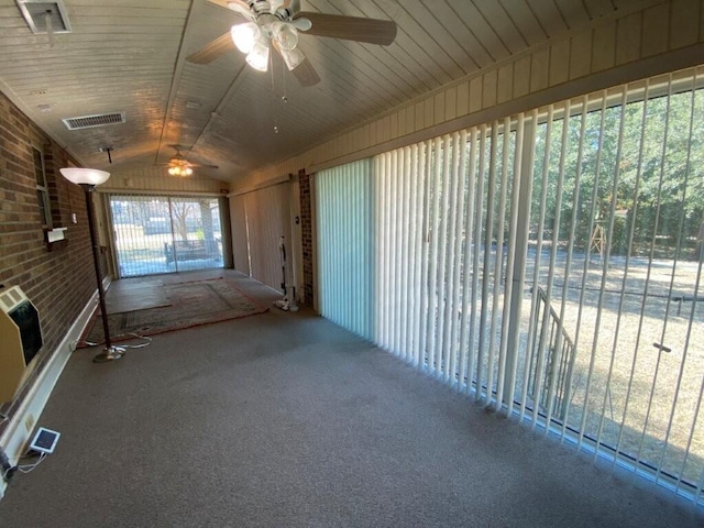 unfurnished sunroom featuring lofted ceiling and heating unit