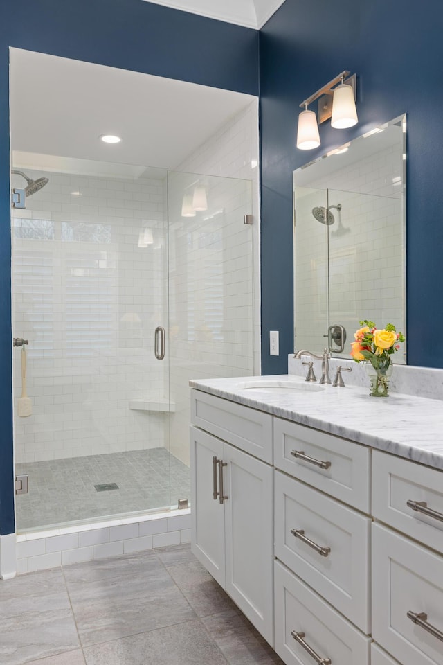 bathroom featuring vanity and a shower with door