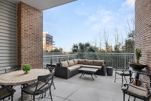 view of patio with a balcony and outdoor lounge area