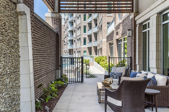 balcony with an outdoor living space and a pergola