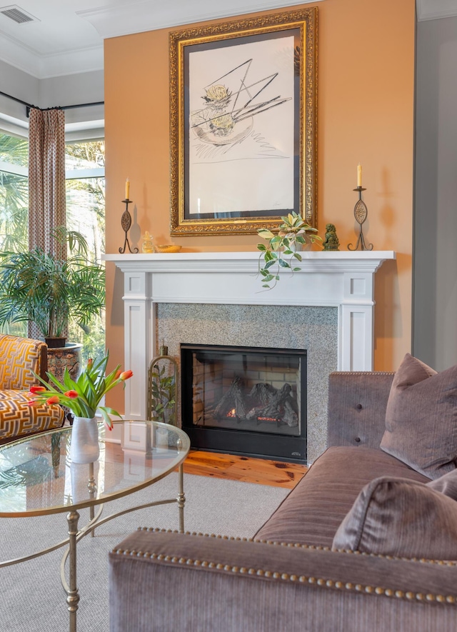 living room featuring wood-type flooring and crown molding