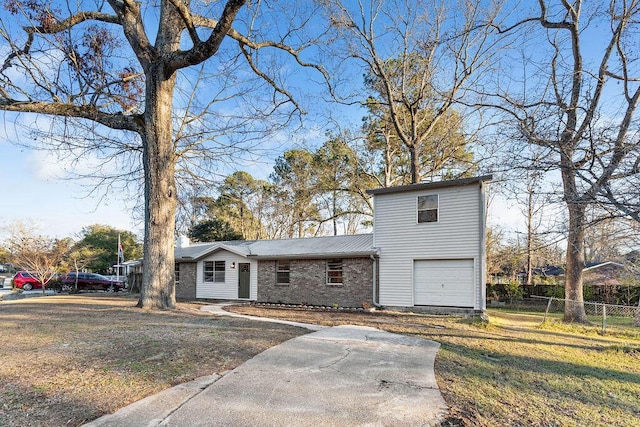 view of front of home with a front yard and a garage