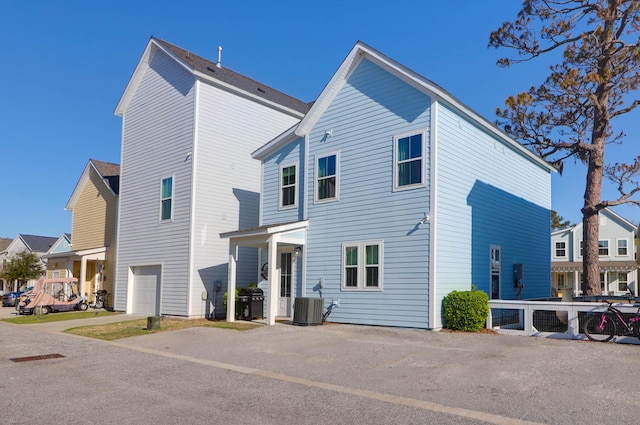 back of house featuring cooling unit