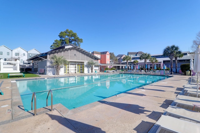 pool featuring a residential view and a patio