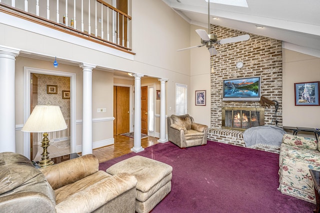 living area featuring a fireplace, decorative columns, lofted ceiling with beams, a ceiling fan, and baseboards