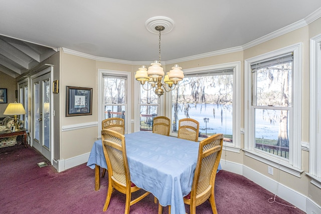 dining room featuring baseboards, a chandelier, carpet flooring, and ornamental molding