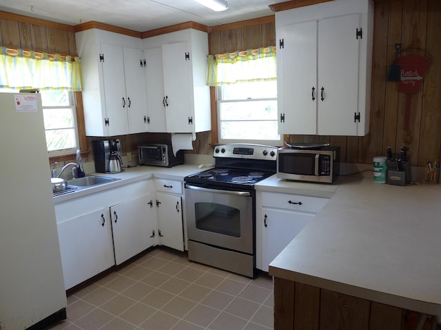 kitchen featuring a sink, appliances with stainless steel finishes, a healthy amount of sunlight, and light countertops