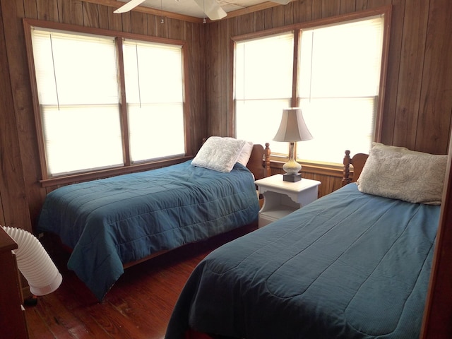 bedroom with wooden walls and wood finished floors