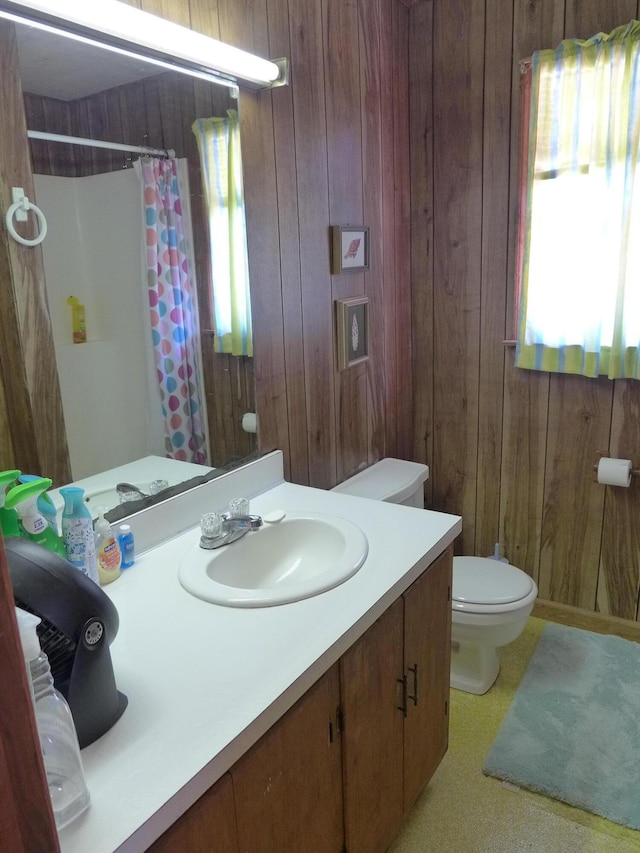 full bathroom featuring wooden walls, toilet, a shower with shower curtain, and vanity
