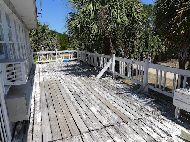 wooden terrace featuring cooling unit