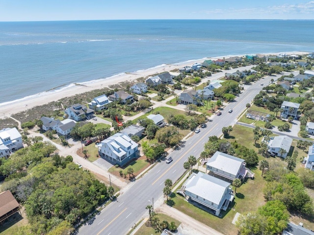 drone / aerial view with a beach view, a residential view, and a water view