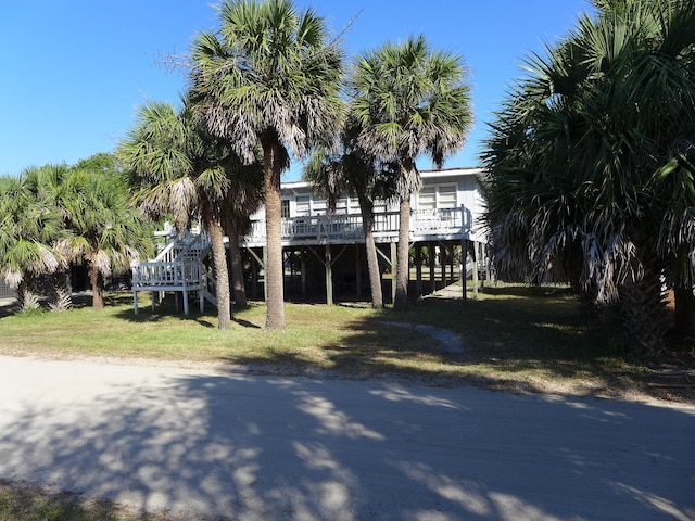exterior space with a wooden deck, stairs, and a carport