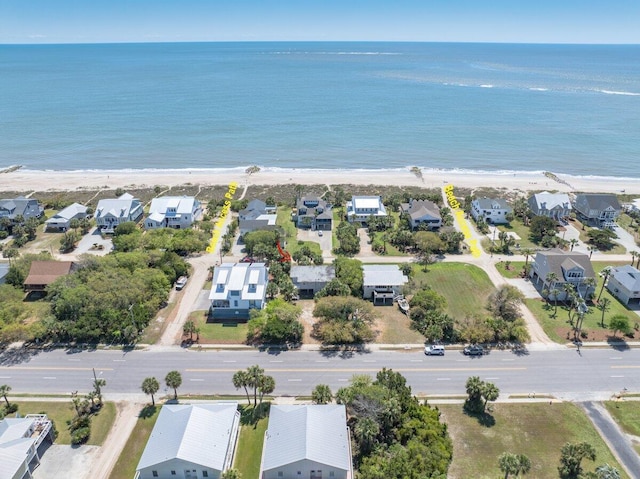 aerial view featuring a beach view, a residential view, and a water view