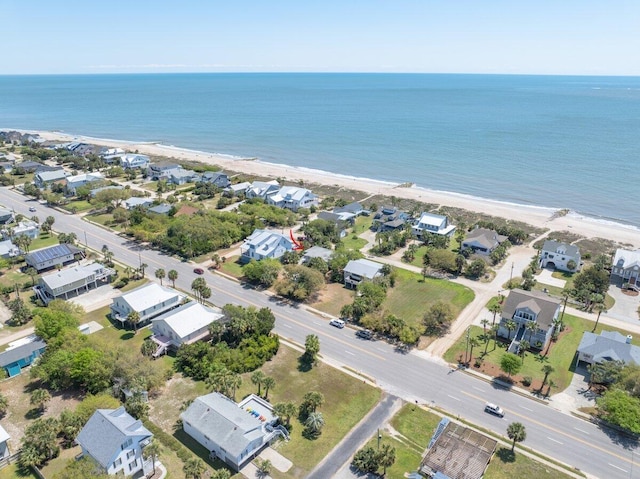 drone / aerial view with a water view, a beach view, and a residential view