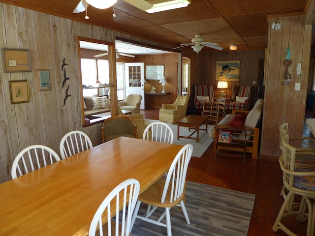 dining room with wooden walls and ceiling fan