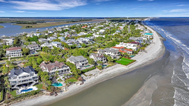 bird's eye view with a water view and a beach view