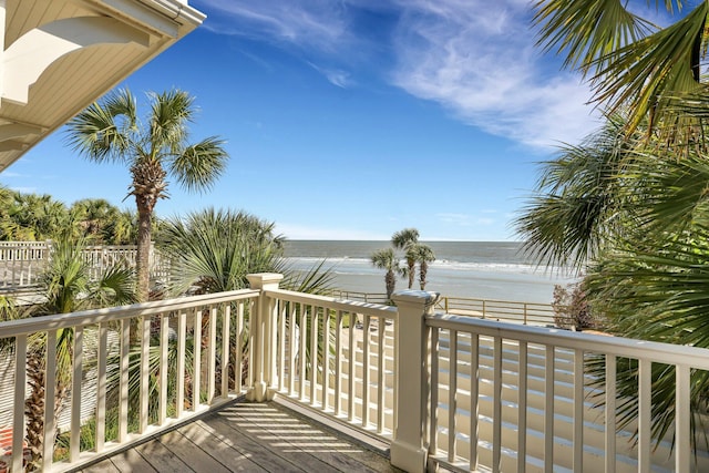 deck with a beach view and a water view