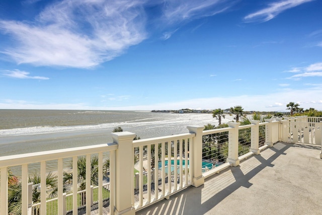 balcony with a view of the beach and a water view