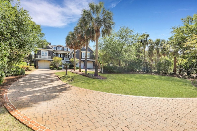 view of front of property with a garage and a front lawn