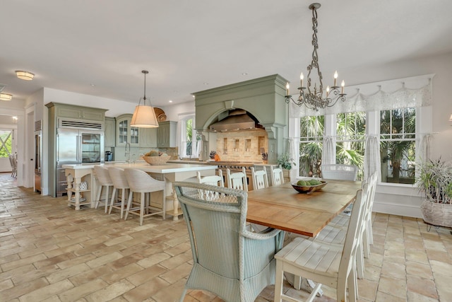 dining space featuring a notable chandelier and sink