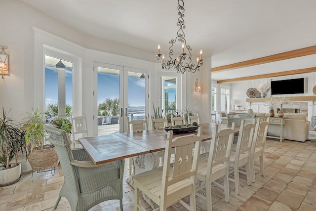 dining room with beam ceiling, french doors, and an inviting chandelier