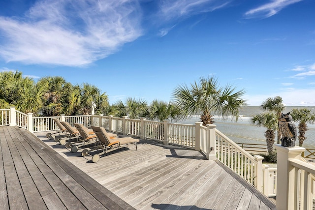 wooden terrace featuring a water view