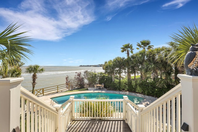 view of pool featuring a beach view and a water view