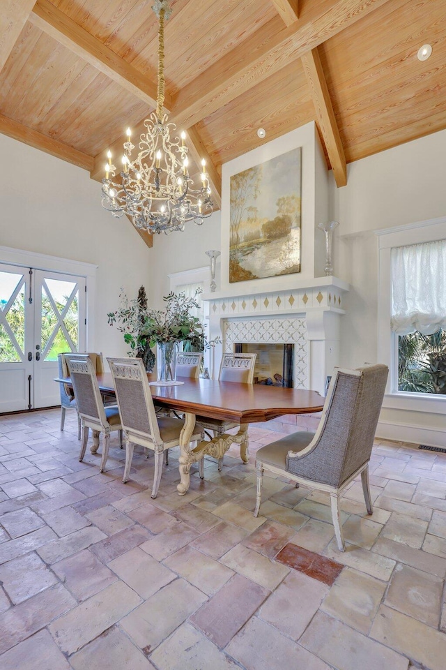 dining space featuring beam ceiling and high vaulted ceiling