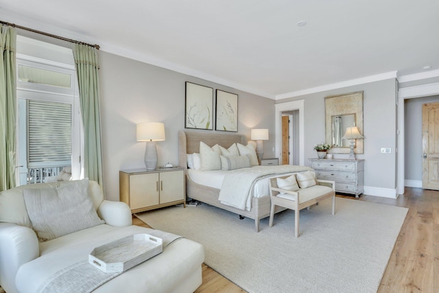 bedroom featuring crown molding and light hardwood / wood-style flooring