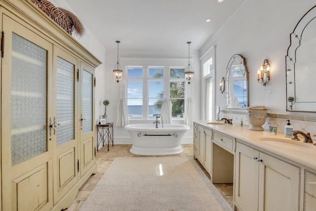 bathroom with french doors, backsplash, a bathtub, ornamental molding, and vanity