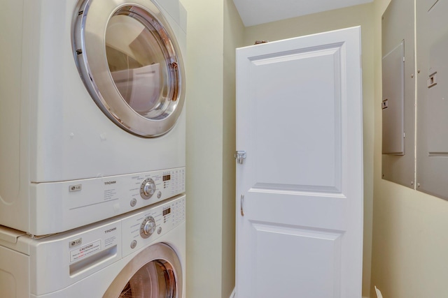 laundry room with stacked washing maching and dryer