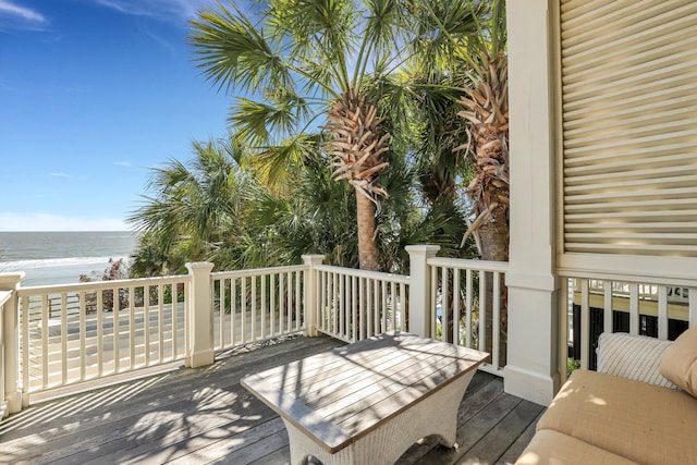 wooden terrace with a water view and a beach view