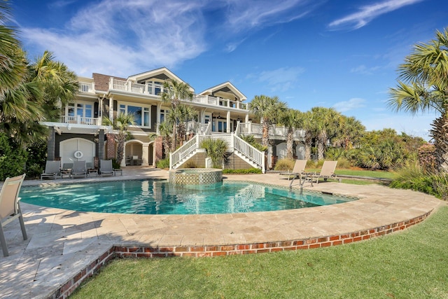 view of swimming pool with a yard and a patio