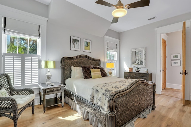 bedroom with multiple windows, light wood-type flooring, and ceiling fan