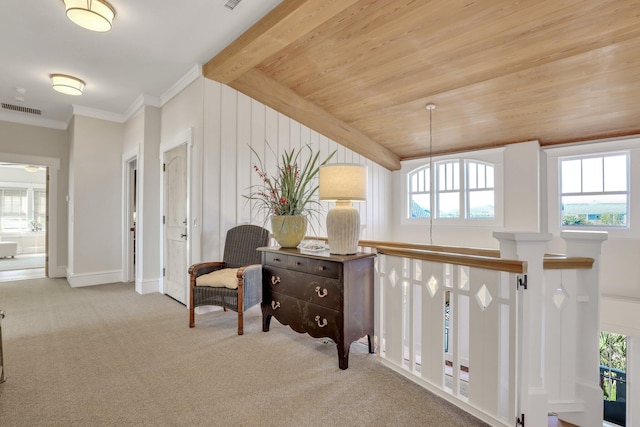 interior space with light colored carpet, plenty of natural light, and wood ceiling