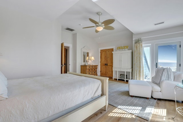 bedroom featuring ceiling fan, light hardwood / wood-style floors, and lofted ceiling