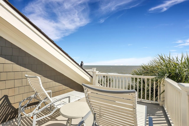 balcony with a beach view and a water view