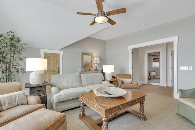 carpeted living room featuring ceiling fan and lofted ceiling