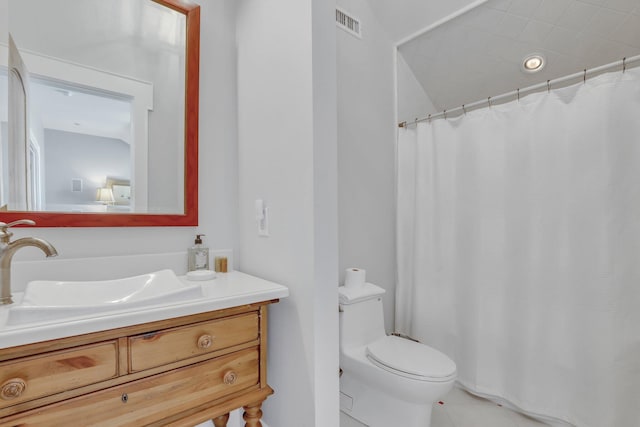 bathroom featuring tile patterned flooring, vanity, and toilet