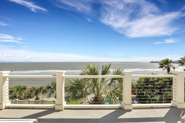 exterior space with a water view and a beach view