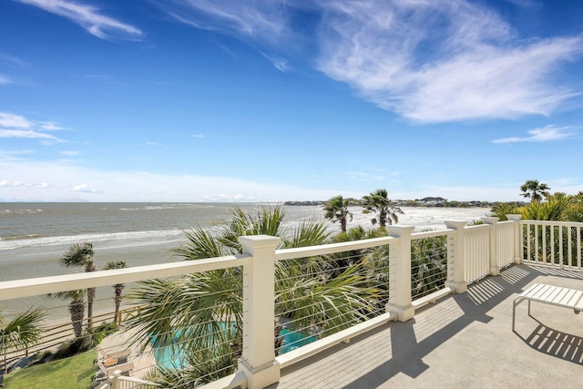 balcony with a view of the beach and a water view