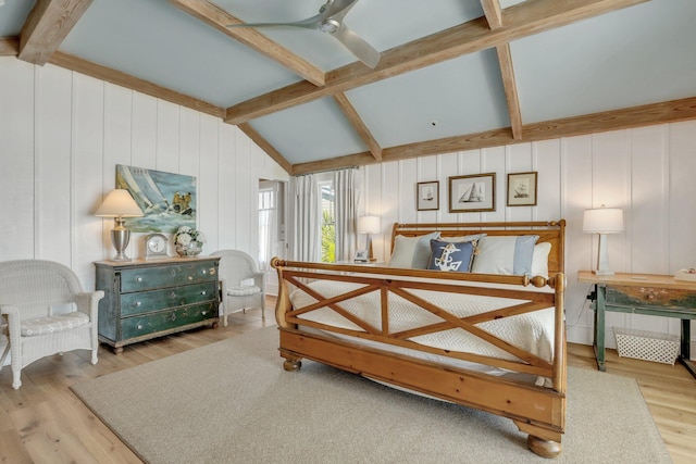 bedroom featuring lofted ceiling with beams, light hardwood / wood-style floors, and ceiling fan