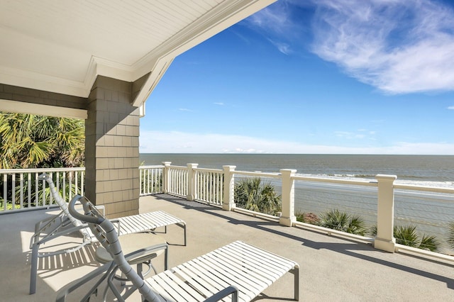 balcony with a water view and a beach view